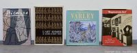 Front view of four art books: Picasso, L'Art Khmer, Frederic Varley, Degenerate Art, showing cover art and titles.