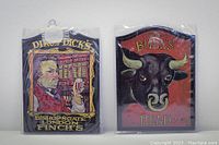 Two English mini pub signs packaged in plastic - Dirk Dick's and The Bull's Head, each 7" x 5"
