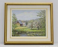 Framed oil painting showing a landscape of spring orchard, trees, pond and buildings, signed by the artist.