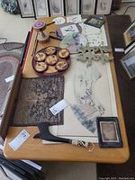 Entire lot arranged on wooden table showing all items