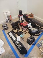 Overall group shot of cameras and accessories on floor