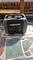 Front view of the Coleman Powermate Pulse 1850 portable generator showing the carrying handle, fuel cap, and vented panel with controls.