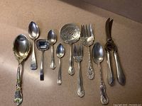 All ten pieces laid out showing enameled spoon, spoons, forks and shears