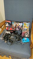 Full lot with games, controllers, headset, charge station shown on chair