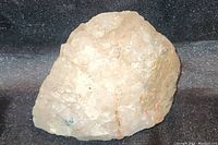 Close-up of large quartz crystal chunk showing crystalline texture and shape.