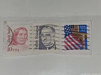 Three vintage used US postage stamps on a small piece of paper with cancellation marks