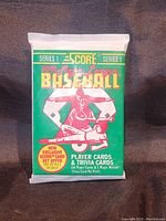Image of a sealed green Score Series 1 Major League Baseball card pack featuring a catcher illustration.