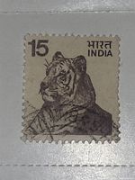 Close-up image of the vintage Indian tiger stamp showing the tiger head and denomination 15.
