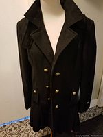 Front view of the Guess black wool pea coat showing double-breasted gold buttons and structured collar.