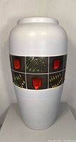 Front view of large white West German Fat Lava floor vase with colorful abstract textured band around the middle.