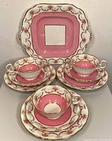 Three trio sets and tray displayed front-on