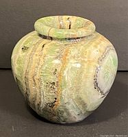 Front view of round onyx vase showing prominent green and beige natural banding and polished finish.