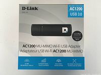 Front of D-Link box displaying AC1200 MU-MIMO Wi-Fi USB adapter details and features.