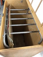 Top view inside blueprint cabinet showing multiple metal rods for hanging drawings and large-format papers.