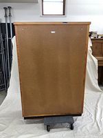 Back view of the wooden blueprint cabinet showing solid back panel and wood trimming top edge.