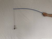 Blue powder-coated fishing pole with birch/maple handle and attached roasting tool shown horizontally against plain background.