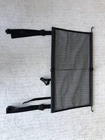 Full view of the Mercedes-Benz cargo net laid flat showing black mesh panel, metal frame, attached straps with buckles, and collapsible design.