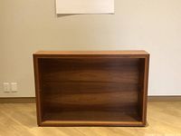 Front view showing the open bookcase frame without shelves, made of cherry wood with natural finish.