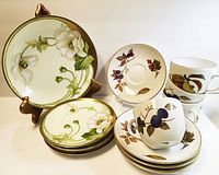 Four Royal Worcester Evesham teacup and saucer sets with hand-painted fruit designs and gold trim.