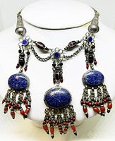 Full view of the Tibetan silver choker showing three large lapis lazuli stones set in silver with coral bead dangles.