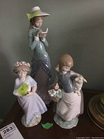 Three Lladro figurines displayed together