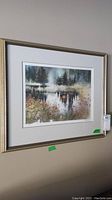 Full view of the framed print hanging on a wall, showing overall condition and framing style.