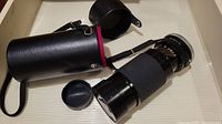Tamron CF Tele Macro 80-210mm telephoto macro lens with front and rear caps.