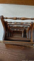 Top view of the nesting baskets stacked inside each other showing the carved spindle handles and slatted bottoms.