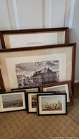 All six framed prints shown grouped on carpet, with larger prints at the back and smaller prints in front.