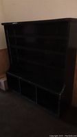 Full view of the vintage dark wood bookcase showing its height and shelf space
