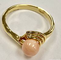 Close-up front angle of the semi-precious pink coral gemstone ring showing the gold electroplated band size 10