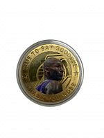 Front side of the commemorative coin with Kobe Bryant's portrait and message.