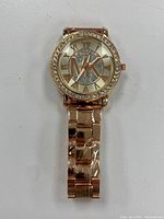 Front view of the gold tone Michael Kors ladies watch showing the full dial with large MK logo and crystal bezel.