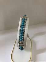 Front angle view of the ladies bracelet showing turquoise beads and Tibetan silver details.