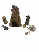 Photo showing the lot of unique antique collectibles including plush, figurines, and miniature tea set arranged on a white background