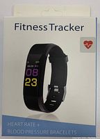 Front of box showing fitness tracker watch with digital time display and heart icon, text indicating 'HEART RATE + BLOOD PRESSURE BRACELETS'.