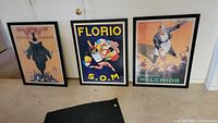 Three black framed Italian inspired wall posters displayed together. One poster lacks glass on the frame.