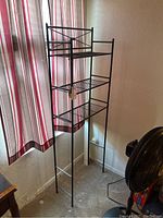 Photo of aluminum-framed shelf with three wire shelves and decorative X-back detail