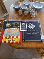 Map and album laid out on a table with dishes in background