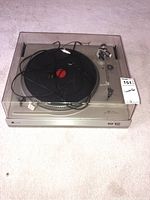 View of the entire Dual CS 508 turntable with clear dust cover and cables on platter.