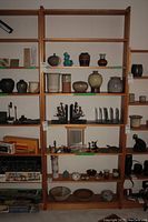 Full view of the wood shelving unit filled with various decorative items and objects, showing seven shelves in total.