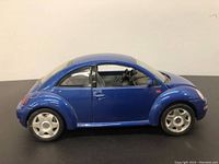 Side view of blue diecast model showing body shape and wheels