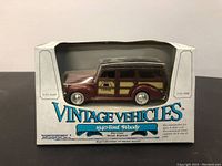 Front view of the 1940 Ford Woody diecast car model in original packaging showing maroon and wood paneling design.