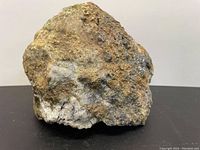 Front view showing quartz matrix with scattered gold flecks