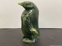 Another side view showing the texture and natural veining of the green stone.