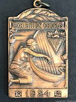 Front of the medal showing the Exhibition Chorus design with a woman playing a harp and swan, marked with '1924' and CNE logo.