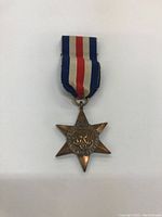 Front side of the medal showing the six-point star shape and central medallion design clearly.