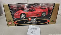 Photo of the packaged red Bburago 1995 Ferrari F50 diecast model in 1:18 scale, showing clear display box with branding and model info.