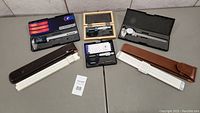 Photo of all items including calipers, micrometers, and rulers arranged on two tables