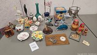 Wide view of the full collection of various collectables and knick knacks arranged on a surface